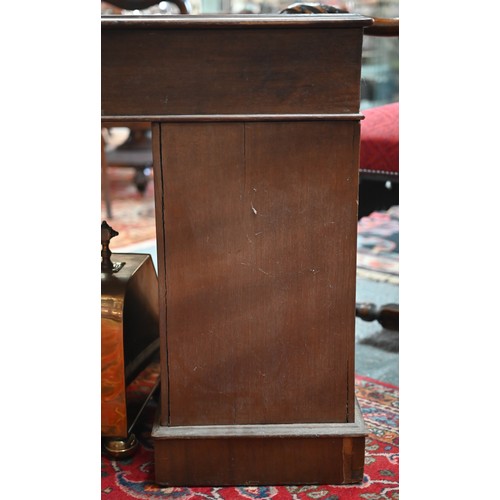 874 - A Victorian walnut twin pedestal desk, the inset tan leather top over an arrangement of moulded edge... 