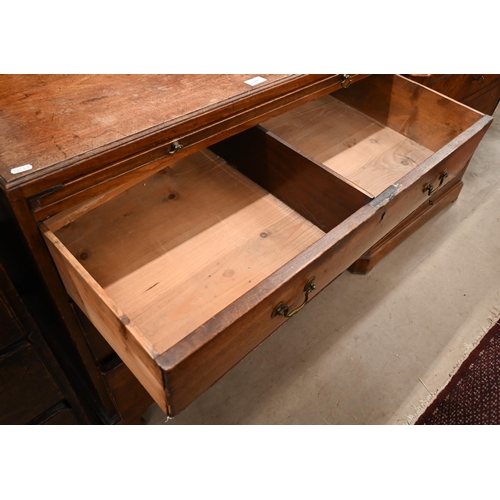 101 - A George III mahogany chest of three long graduating drawers below brush slide, raised on shaped bra... 