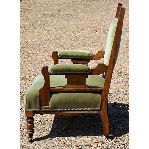 163 - # An Edwardian green dralon upholstered walnut framed salon armchair, on castors