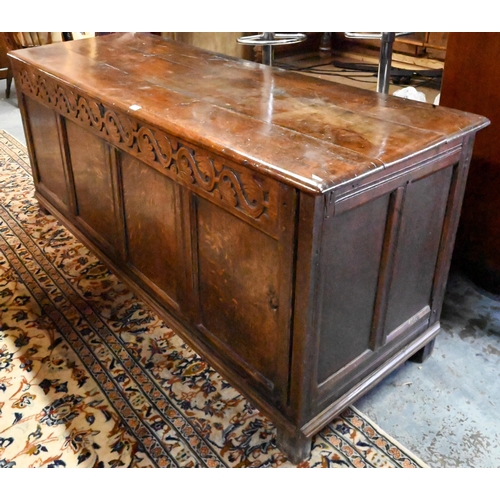 352 - A very large early 18th century oak coffer, the three plank top over a moulded frieze and four panel... 