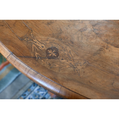 104 - A Victorian walnut and satin inlaid loo table with oval quarter-veneered top on four turned pillars ... 