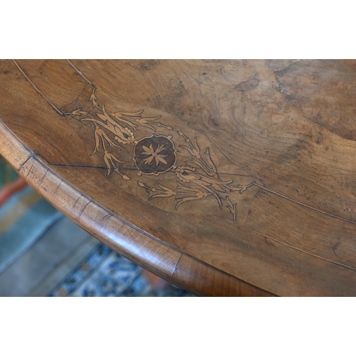 104 - A Victorian walnut and satin inlaid loo table with oval quarter-veneered top on four turned pillars ... 