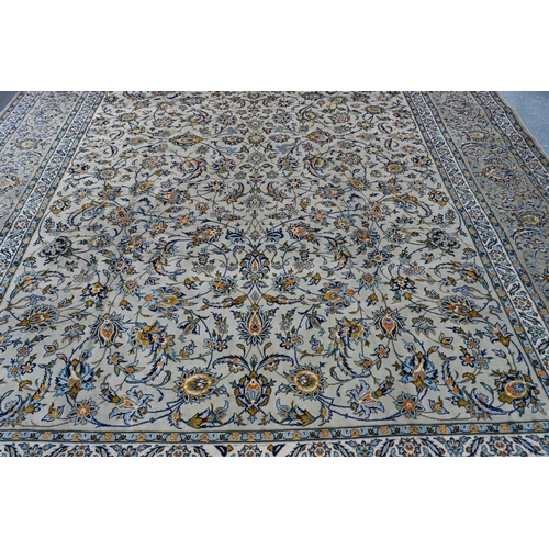 108 - A Persian cream ground Kashan carpet of tradiitonal stylised floral design, with palmette repeating ... 