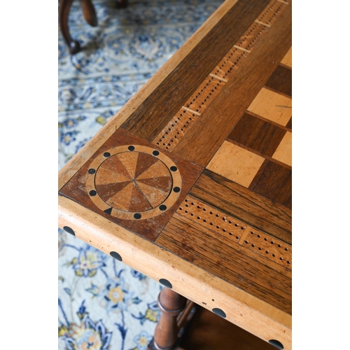 109 - A hardwood marquetry square games table with turned supports and undertier, 65 x 65 x 72 cm high