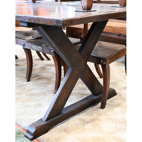 110 - An oak refectory dining table with cleated triple plank top on braced cross-trestle supports, 230 x ... 