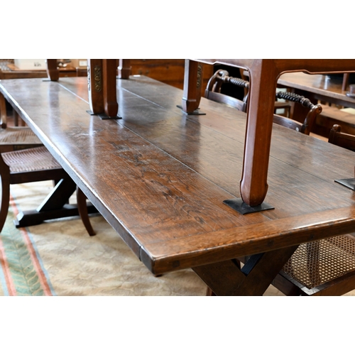 110 - An oak refectory dining table with cleated triple plank top on braced cross-trestle supports, 230 x ... 