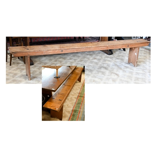 121 - A pair of antique stained pine benches, 250 cm long x 48 cm high