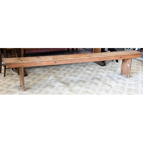 121 - A pair of antique stained pine benches, 250 cm long x 48 cm high