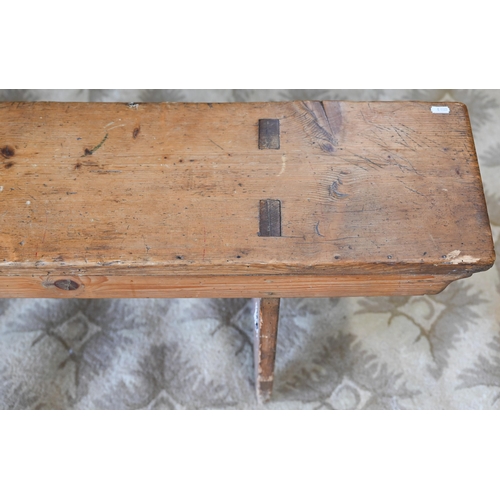 121 - A pair of antique stained pine benches, 250 cm long x 48 cm high