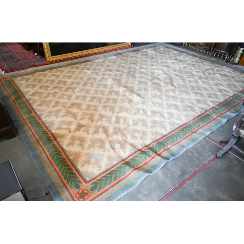 122 - A Stockwell Carpets wool carpet (made in Thailand) of repeating design on beige ground framed by mul... 