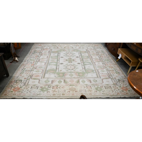 131 - A Turkish Milas carpet in pastel hues with geometric design