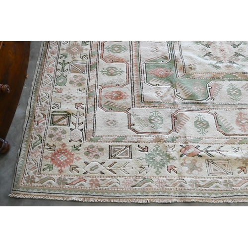 131 - A Turkish Milas carpet in pastel hues with geometric design