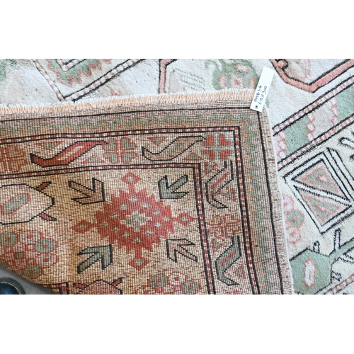 131 - A Turkish Milas carpet in pastel hues with geometric design