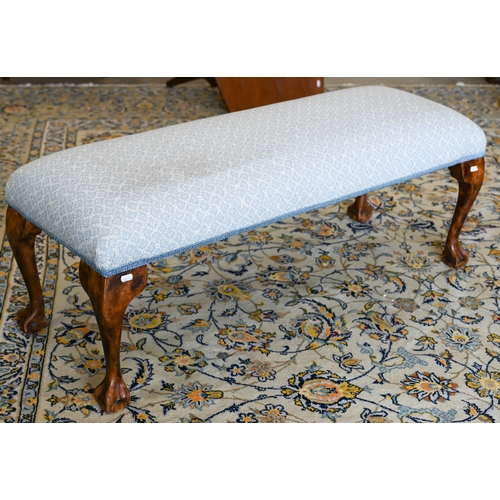 141 - A walnut framed footstool with blue and white patterned fabric and cabriole supports, 108 x 40 x 42 ... 