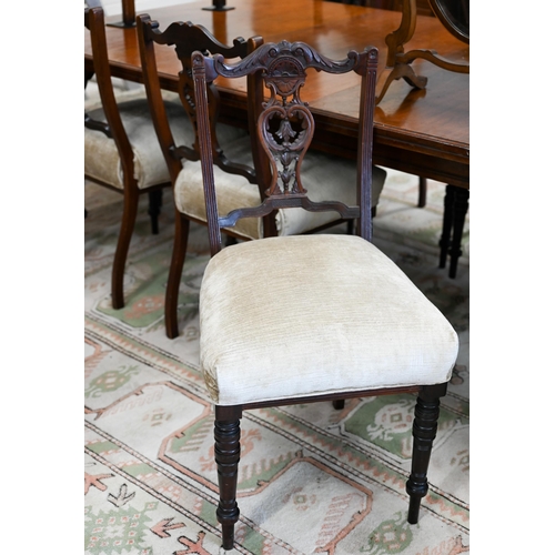 144 - A set of Edwardian mahogany side chairs by Heals with champagne chenile overstuffed seats on turned ... 