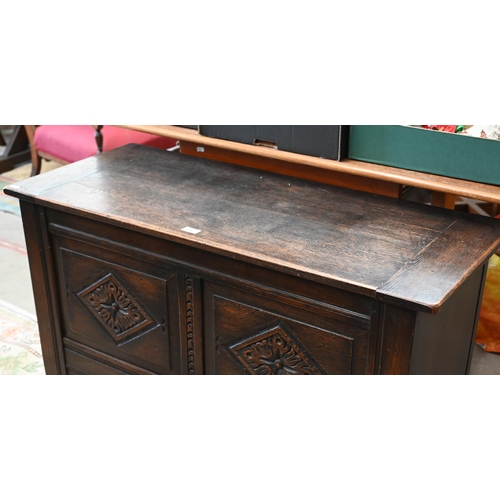 145 - # A dark oak coffer with hinged top and carved front panels, 106 x 46 x 64 cm high