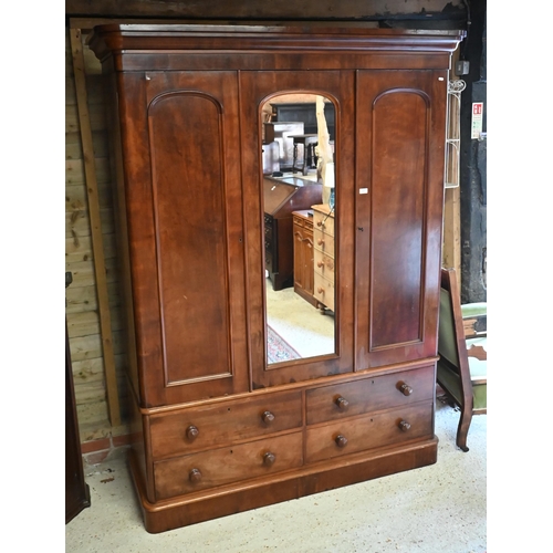 152 - A 19th century mahogany wardrobe with central arched mirror between panelled doors on a four drawer ... 