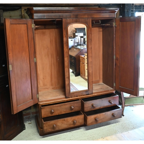 152 - A 19th century mahogany wardrobe with central arched mirror between panelled doors on a four drawer ... 