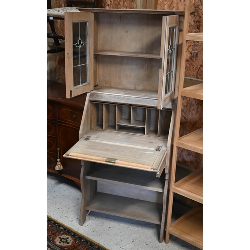 159 - An Arts & Crafts limed oak bureau display cabinet with stained and leaded glass doors in the Lib... 