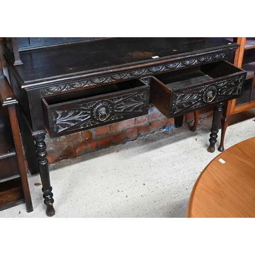 183 - A Gothic Revival carved oak dresser with plate rack and two drawer base with turned supports, 138 x ... 