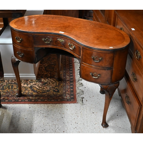 201 - A walnut crossbanded kidney shaped dressing table with five drawers on shell carved cabriole support... 