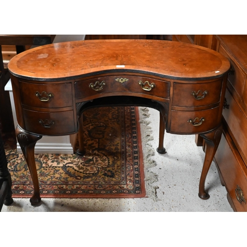 201 - A walnut crossbanded kidney shaped dressing table with five drawers on shell carved cabriole support... 