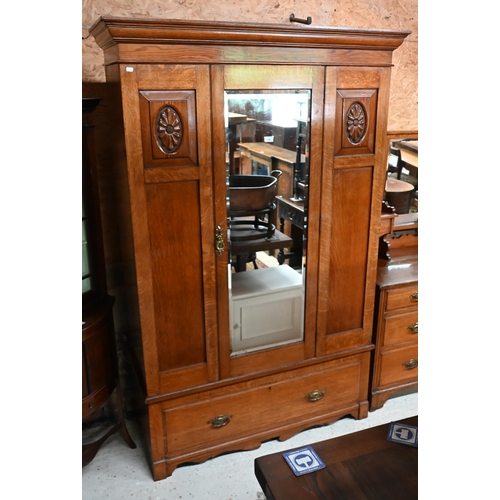 204 - An Edwardian Golden Oak wardrobe with mirrored door over single drawer, 130 x 55 x 205 cm