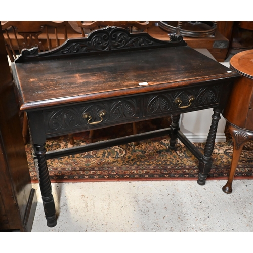 205 - An early 20th century carved oak hall table with two drawers and spiral turned supports united by st... 