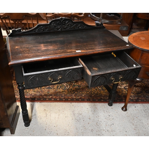 205 - An early 20th century carved oak hall table with two drawers and spiral turned supports united by st... 