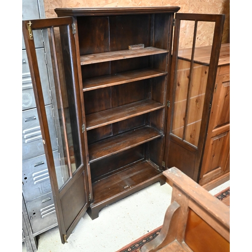 218 - An oak two door bookcase with glazed and panelled front, on bracket feet, 80 x 30 x 154 cm high