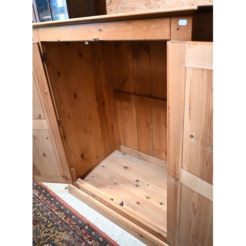 219 - A stained pine children's wardrobe with panelled doors enclosing hanging rail, 92 x 55 x 120 cm high