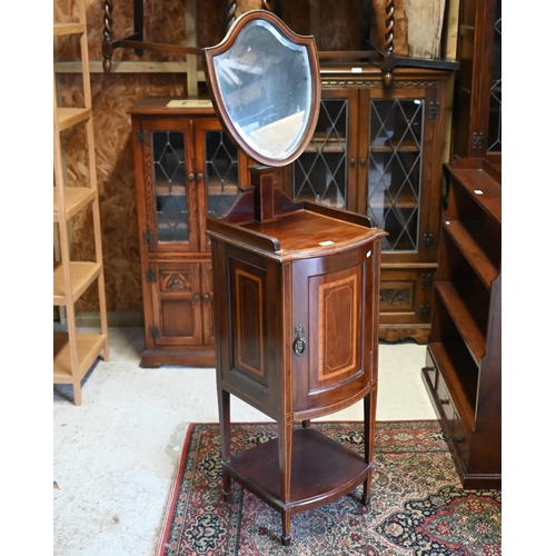 234 - An Edwardian mahogany inlaid vanity stand with bevelled shield shaped mirror and panelled cupboard, ... 