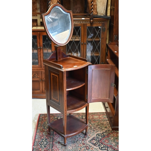 234 - An Edwardian mahogany inlaid vanity stand with bevelled shield shaped mirror and panelled cupboard, ... 