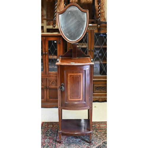 234 - An Edwardian mahogany inlaid vanity stand with bevelled shield shaped mirror and panelled cupboard, ... 