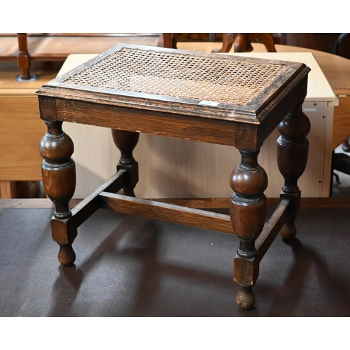 239 - # An early 20th century oak cane worked stool, on turned legs with stretchers, 50 x 40 x 45 cm high