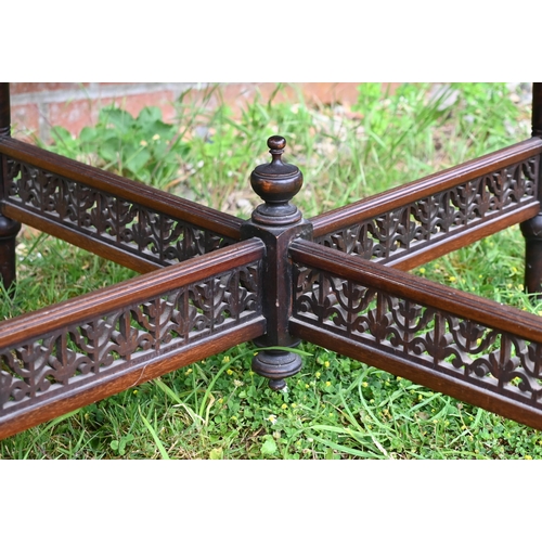 241 - # An Edwardian rosewood inlaid octagonal table on turned supports united by fret-cut cross stretcher... 