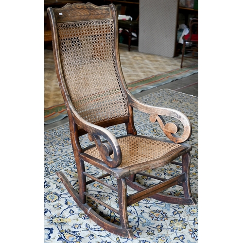 253 - An antique Continental rocking chair with caned back and seat, wooden frame with grained painted fin... 