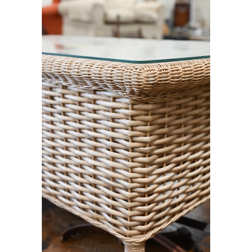 255 - A Laura Ashley rattan wicker glass top coffee table, 102 x 50 x 50 cm high