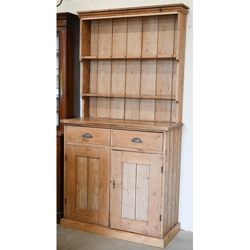 259 - An antique pine dresser two shelf plate rack on base with drawers over panelled cupboards, 110 x 46 ... 