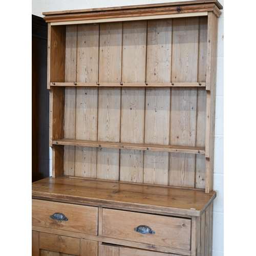 259 - An antique pine dresser two shelf plate rack on base with drawers over panelled cupboards, 110 x 46 ... 