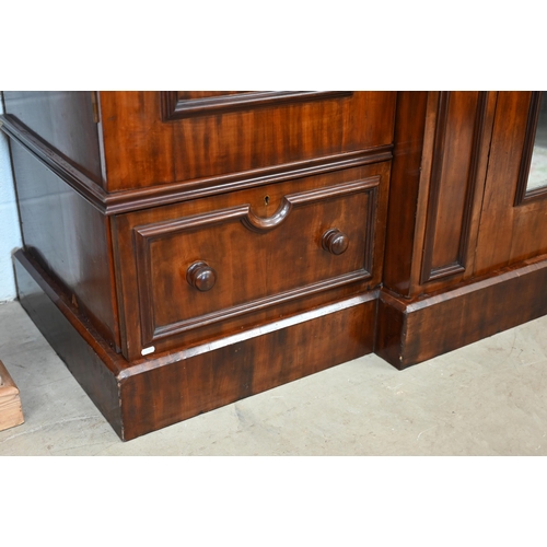 260 - A 19th century mahogany breakfront triple wardrobe, the central mirrored door flanked by panelled do... 