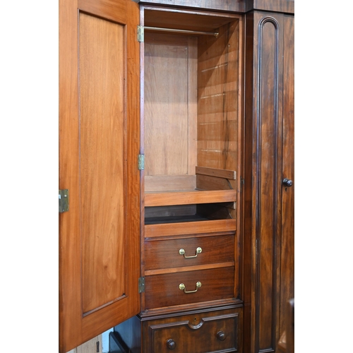 260 - A 19th century mahogany breakfront triple wardrobe, the central mirrored door flanked by panelled do... 