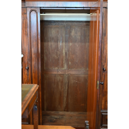 260 - A 19th century mahogany breakfront triple wardrobe, the central mirrored door flanked by panelled do... 