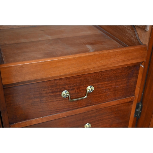 260 - A 19th century mahogany breakfront triple wardrobe, the central mirrored door flanked by panelled do... 