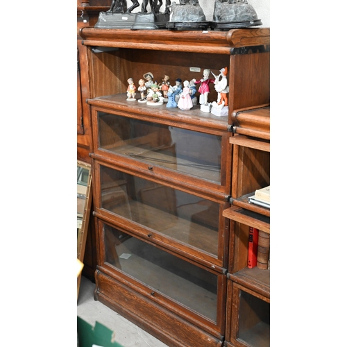 262 - Four oak Globe Wernicke library bookcases, the largest with four graduated glazed in sections, on a ... 