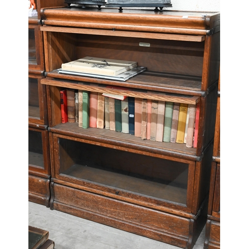 262 - Four oak Globe Wernicke library bookcases, the largest with four graduated glazed in sections, on a ... 