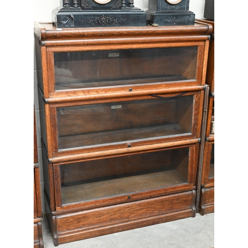 262 - Four oak Globe Wernicke library bookcases, the largest with four graduated glazed in sections, on a ... 