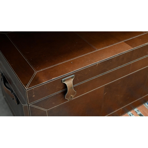 264 - A contemporary brown leather-bound blanket chest, with carrying handles to sides, the interior with ... 