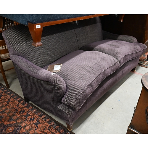 272 - A modern Howard style three seat sofa, upholstered in Fleurons d'Helane Wilton damson fabric, raised... 