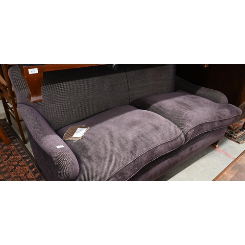 272 - A modern Howard style three seat sofa, upholstered in Fleurons d'Helane Wilton damson fabric, raised... 